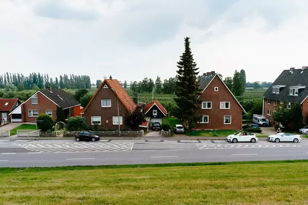 Picture of a typical German countryside with buildings facing the road and fields in the background