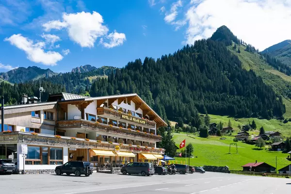Picturesque old hotel in Swiss countryside surrounded by mountains and hills