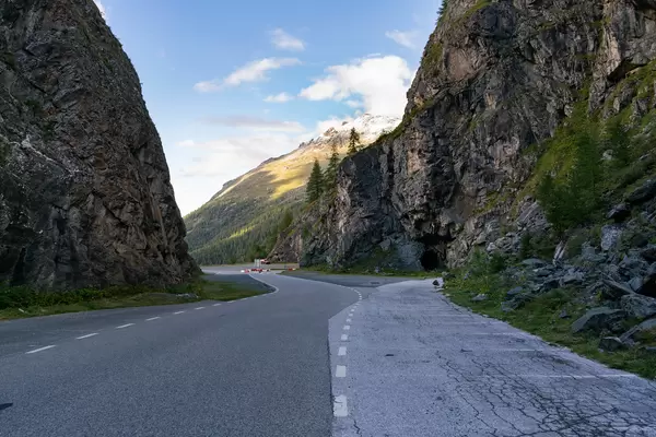 Picturesque Swiss road between cliffs leading to the tunnel