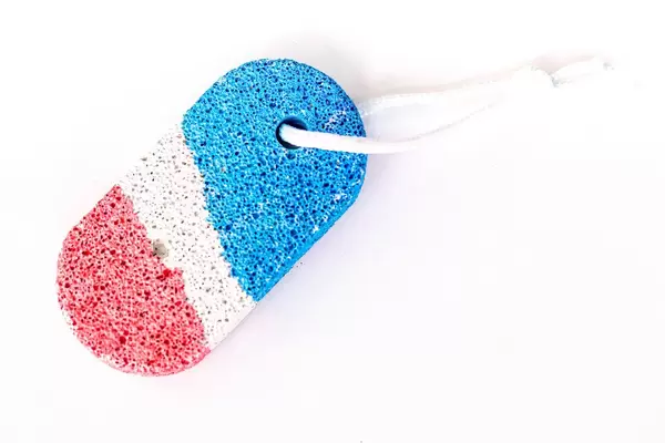 Piece of color pumice with rope on a white background