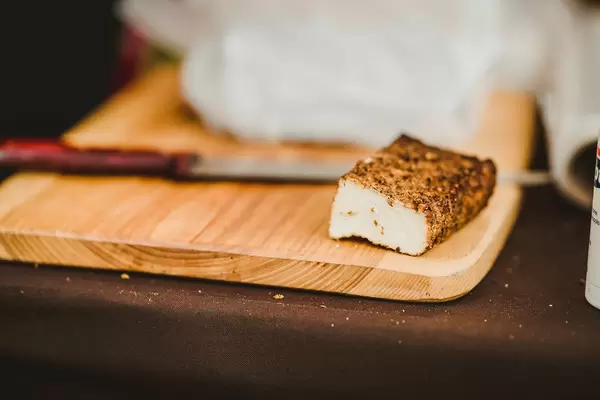 Piece Of Smoked Cheese On Wooden Plate