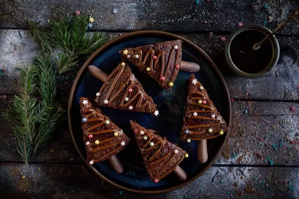 Pieces of christmas chocolate cake on a plate with tea