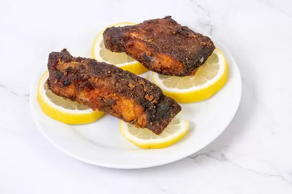 Pieces of fried Carp fish with Lemons on the plate (Flip 2019)