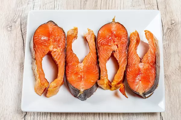 Pieces of smoked salmon on a white plate. The view from the top (Flip 2019)