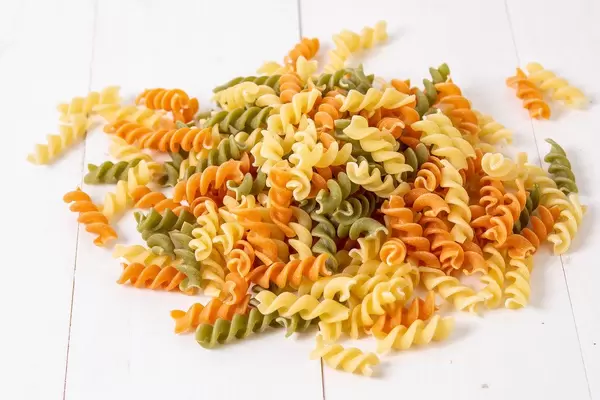 Pile of Colored Pasta on the white table (Flip 2019)