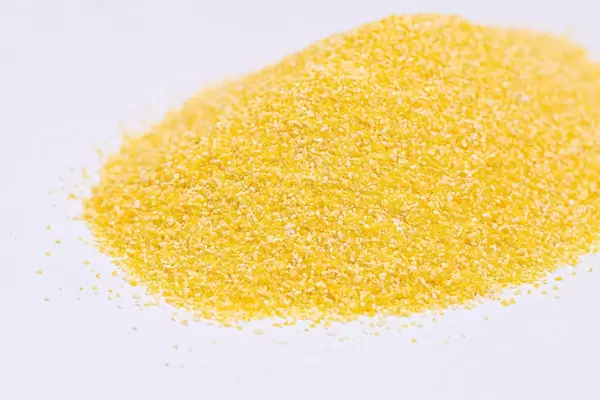 Pile of Corn Grits above grey marble table