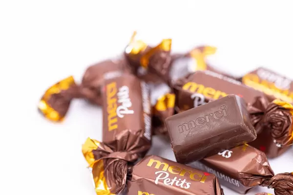 Pile of Dark Chocolate Candies in the Merci Petit paper