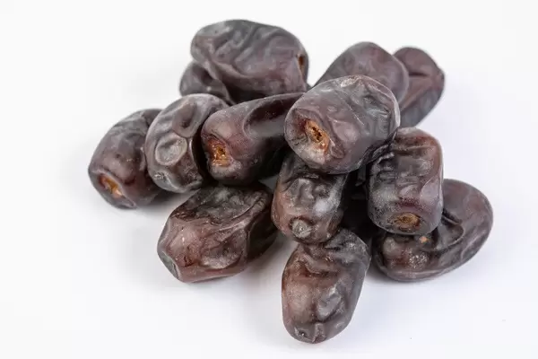 Pile of Date palm fruits on the white background