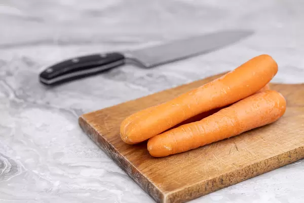 Pile of fresh Carrots on the cutting board