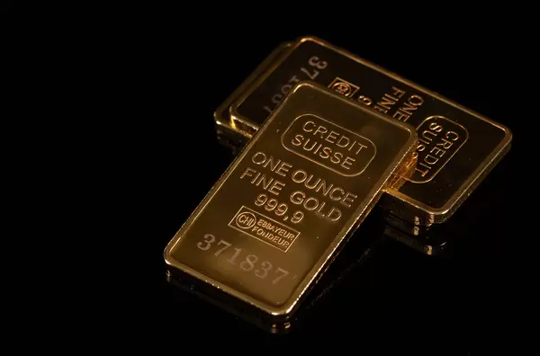 Pile of gold bars on black background