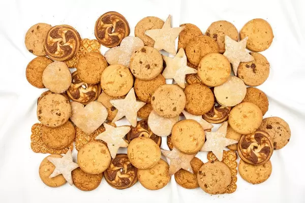 Pile of sweet cookies on white background