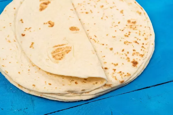 Pile of Tortillas on the blue wooden table (Flip 2020)