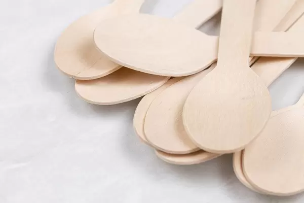 Pile of Wooden Spoons on the grey marble table