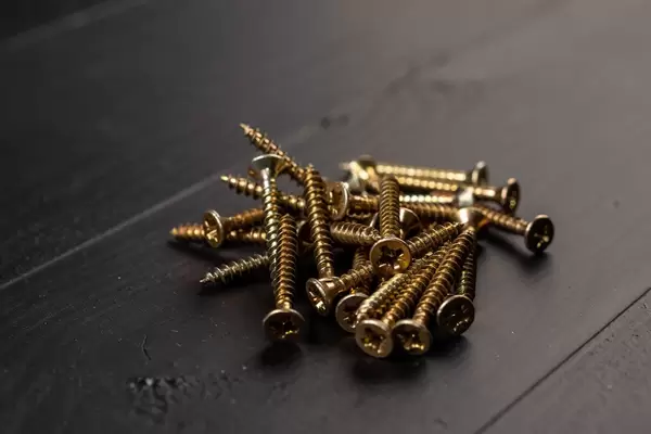 Pile of yellow Screws on the black background