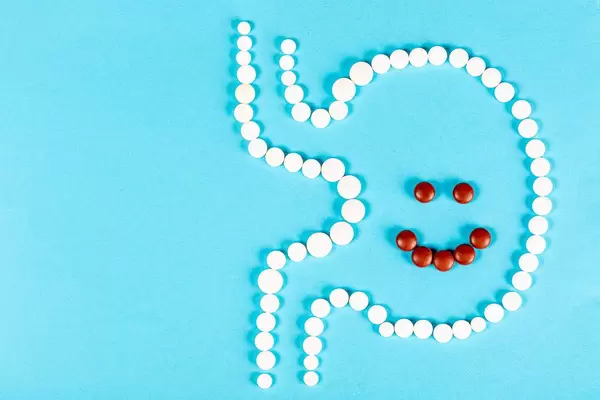 Pill stomach on blue with smiling face