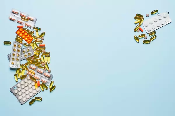 Pills and medical drugs on light blue banner background