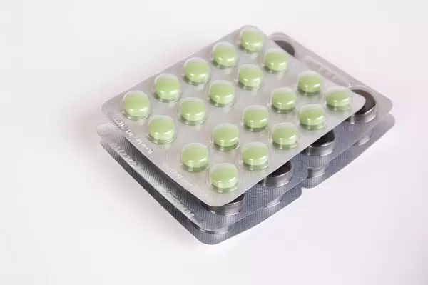 Pills packed in blisters isolated on white