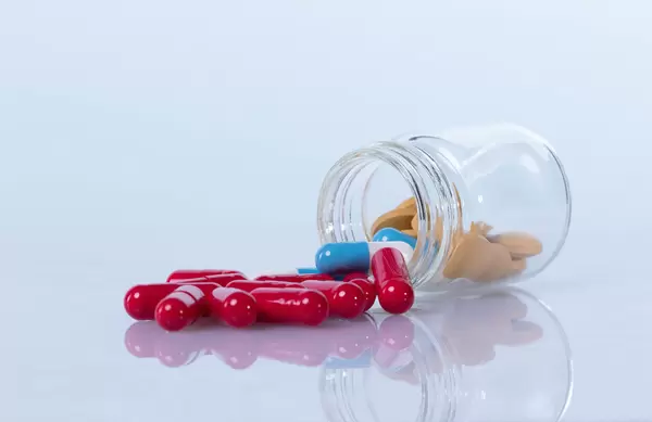Pills spilling out of a bottle