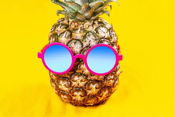 Pineapple in round sunglasses on a yellow background (Flip 2020)