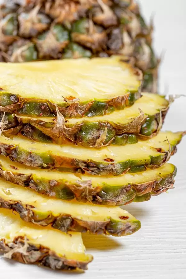 Pineapple, sliced into half rings close up