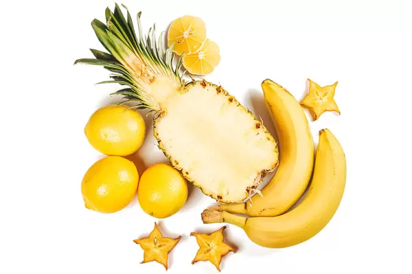 Pineapple with lemons, bananas and slices of caramboli, top view