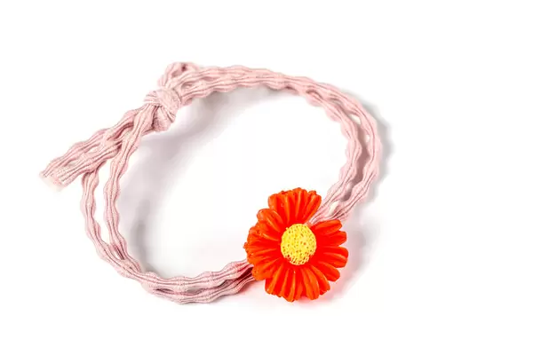Pink elastic hair band with red flower