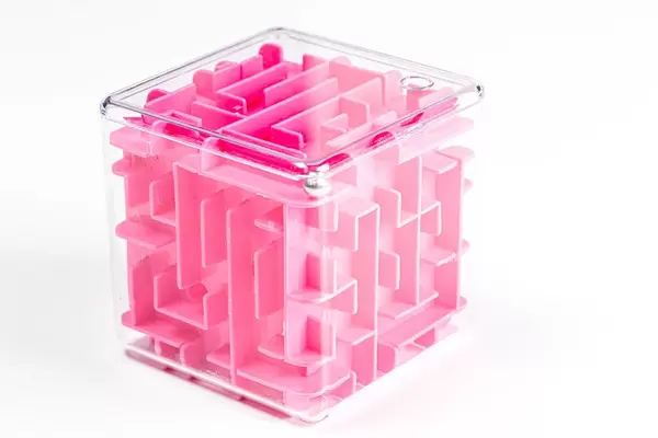 Pink maze cube on white background