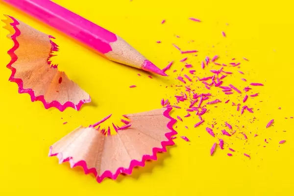 Pink pencil close-up with shavings and sharp tip