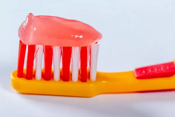 Pink Toothpaste on a Baby Toothbrush