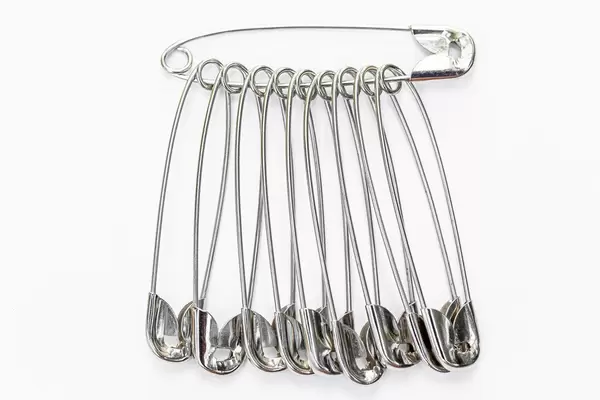 Pins metal for clothing on white background