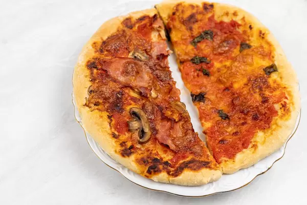Pizza Capricciosa and Pizza Margharita on the table