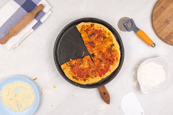 Pizza Capricciosa on the table with cutted slice