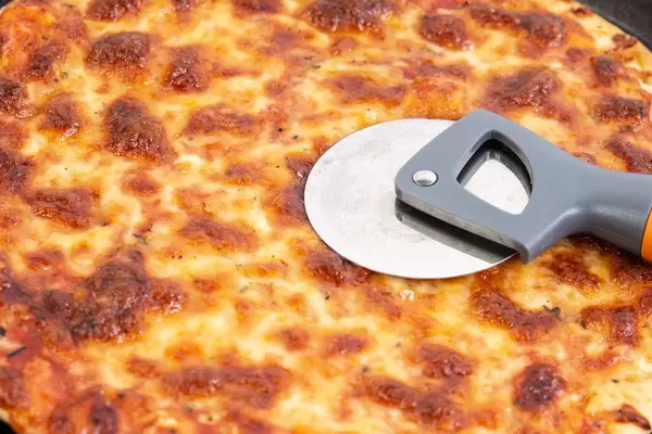 Pizza Margarita with round pizza knife