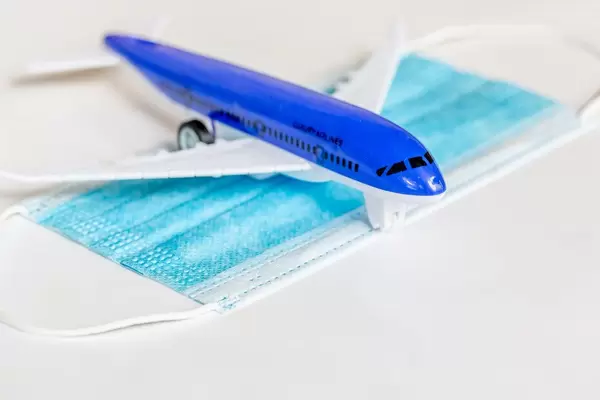 Plane model and medical blue mask. Concept personal protection