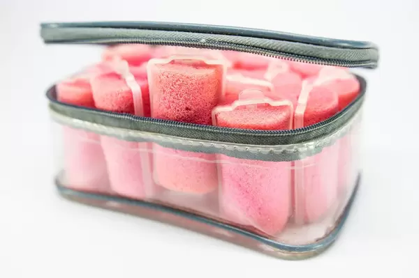 Plastic case with many pink sponge hair curlers (Flip 2019)