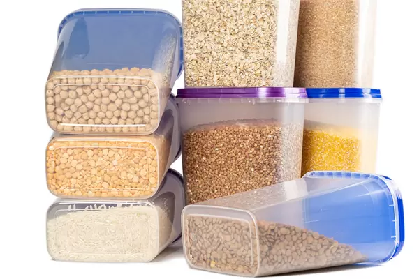 Plastic containers filled with cereals, concept of organization of storage of bulk cereals on the kitchen