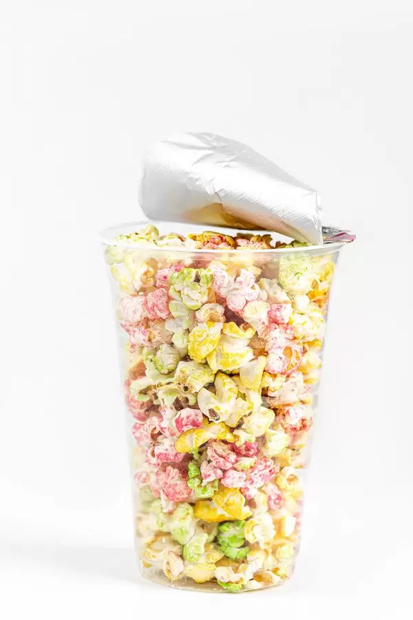 Plastic cup with multi-colored sweet popcorn
