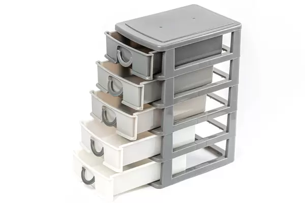 Plastic drawer with open cells on white background