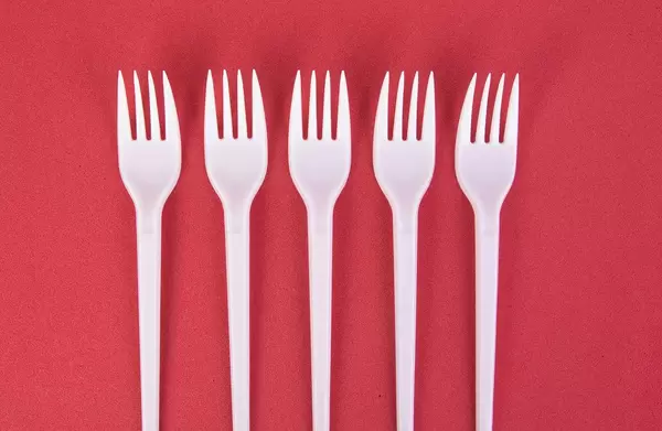 Plastic forks on red background