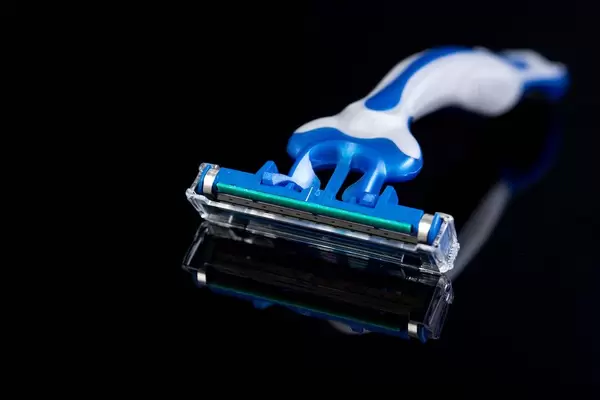 Plastic Razor above black background