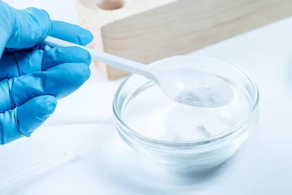 Plastic spoon with white powder. Working with reagents (Flip 2020)