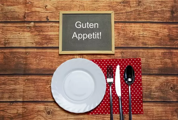 Plate, knife and fork on napkin cloth