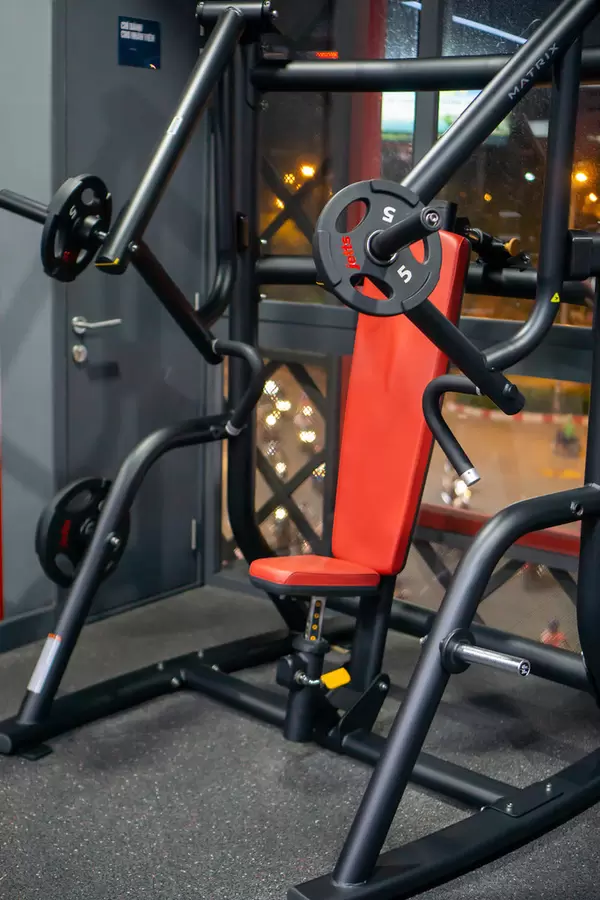 Plate Loaded Free Weight Chest Press Machine with Adjustable Seat in a Gym