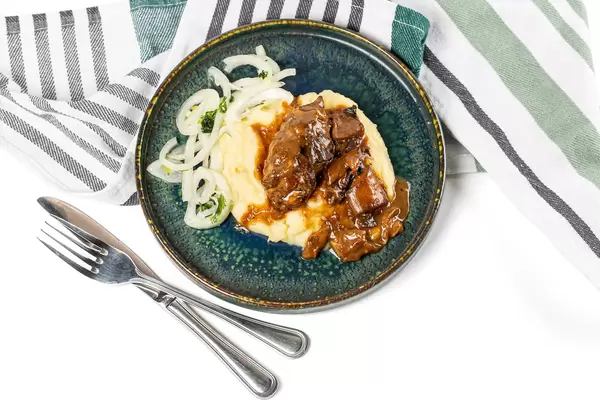 Plate of mashed potatoes with mushroom gravy