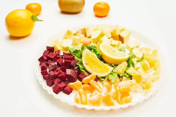 Plate of sliced fruits and vegetables for weight losing