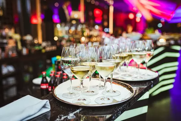 Plate Of White Wine In Restaurant Lights