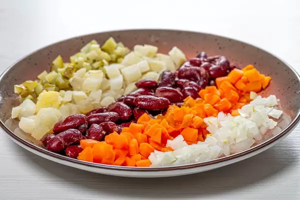Plate with sliced boiled vegetables and pickles with onions (Flip 2019)