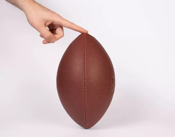 Player holding a football ready for kicking