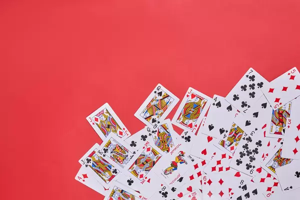 Playing cards on red backdrop