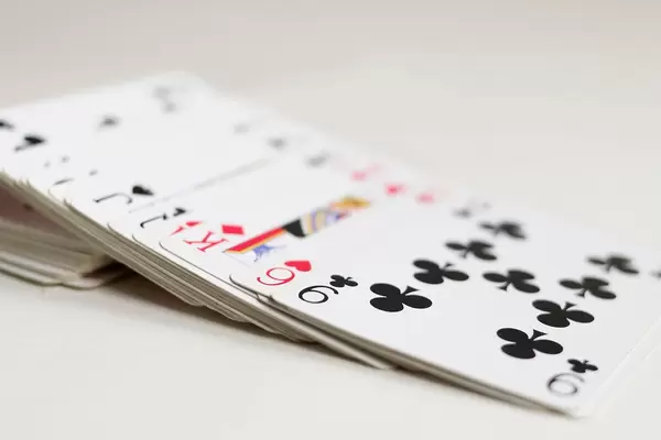 Playing cards slided from a deck close up on a white background